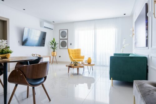 a living room filled with furniture and a flat screen tv