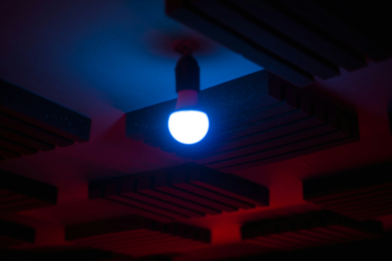 A glowing light bulb hangs from the ceiling